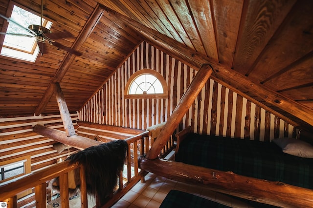 stairway featuring vaulted ceiling with skylight, wood ceiling, and tile patterned floors