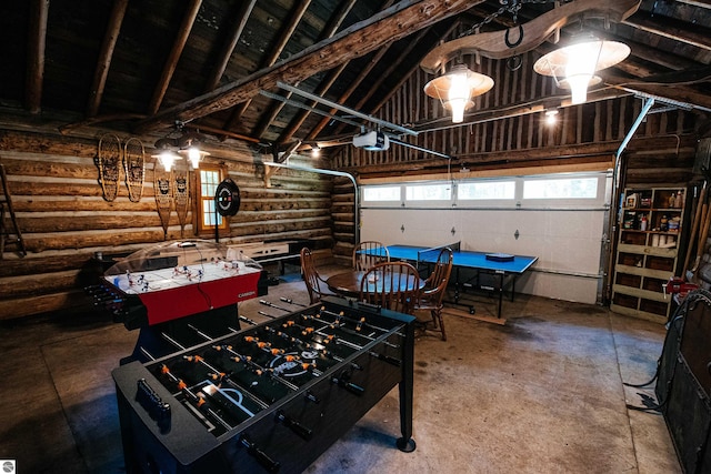 playroom with vaulted ceiling with beams and concrete floors