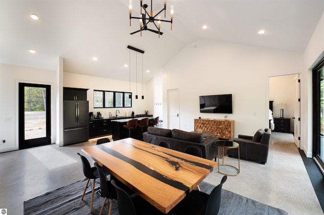 dining space featuring a chandelier and high vaulted ceiling