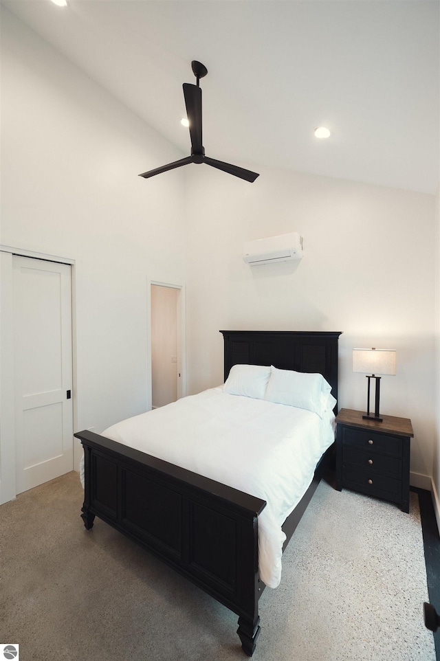 bedroom featuring ceiling fan, a wall mounted air conditioner, and high vaulted ceiling