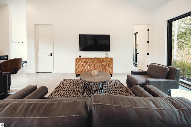 living room with high vaulted ceiling