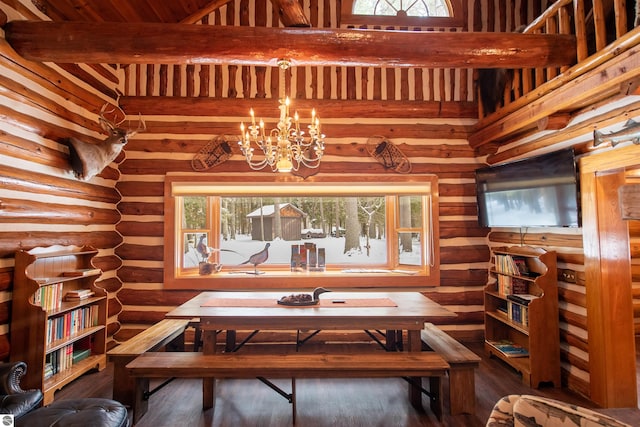 dining space featuring a healthy amount of sunlight, log walls, and an inviting chandelier