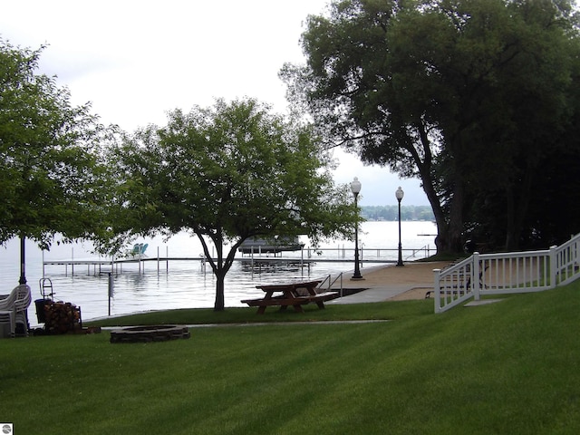 1246 Sunnyside Dr Unit 304Week 8, Cadillac, MI 49601 - view of community with a lawn, a water view, and a dock