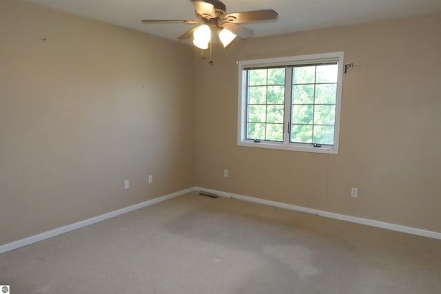 carpeted empty room with ceiling fan