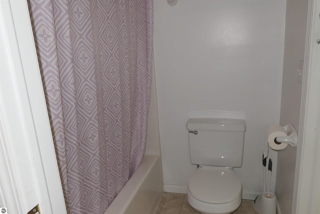 bathroom with tile patterned flooring, toilet, and shower / bath combo