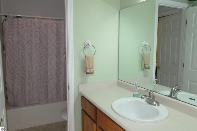 full bathroom featuring vanity, shower / bath combo with shower curtain, toilet, and tile patterned flooring