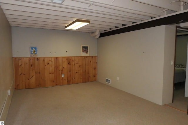 basement with wooden walls and carpet flooring