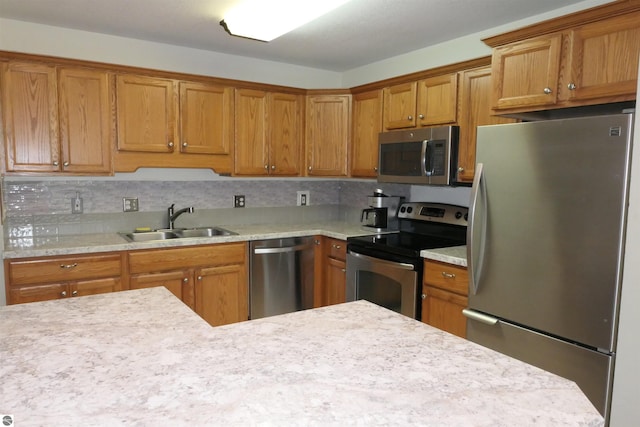 kitchen featuring stainless steel appliances, backsplash, and sink