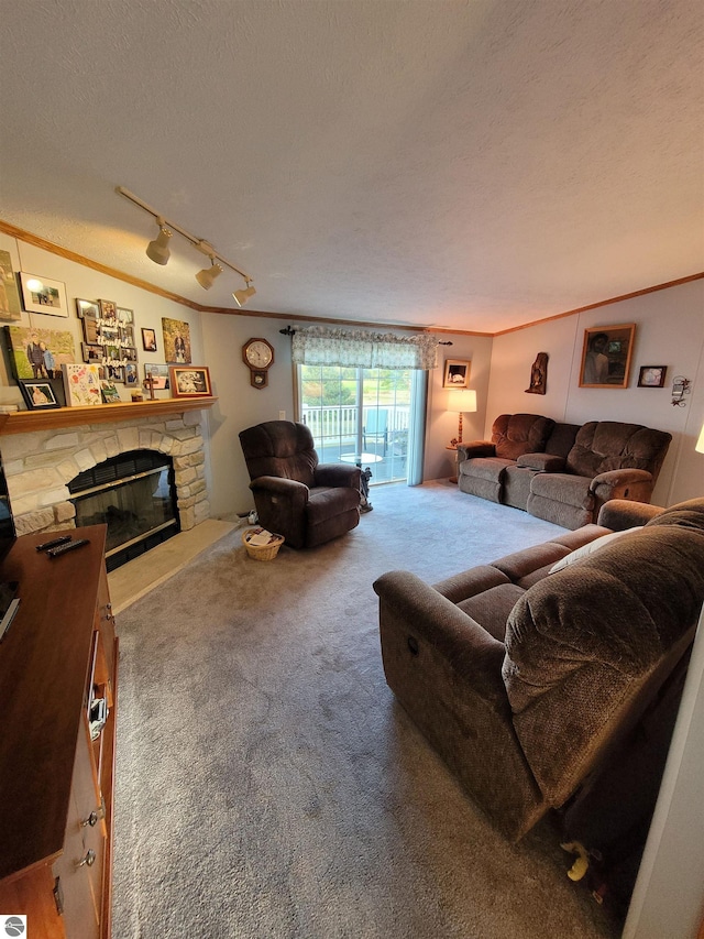 living room with ornamental molding, carpet, a textured ceiling, and a stone fireplace