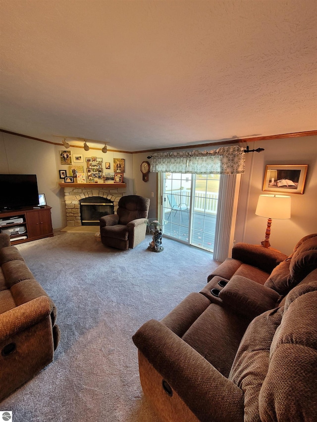 carpeted living room with a textured ceiling, crown molding, and a stone fireplace