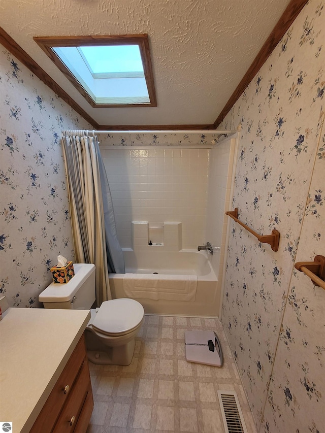 full bathroom with shower / bath combo, a textured ceiling, a skylight, ornamental molding, and toilet