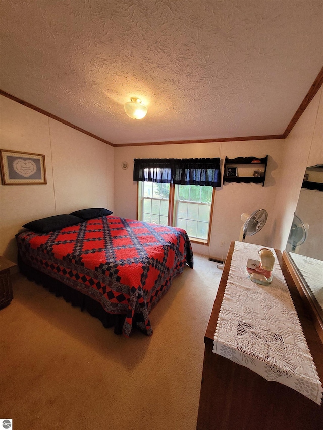 bedroom with a textured ceiling, carpet flooring, and ornamental molding