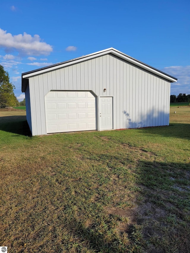 garage featuring a lawn