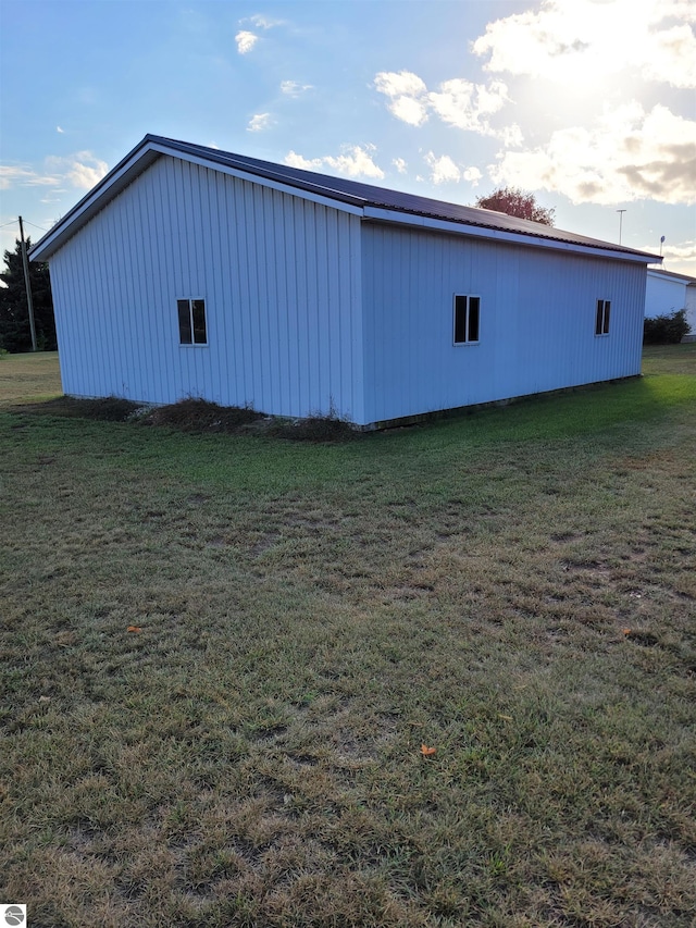 view of side of home with a lawn