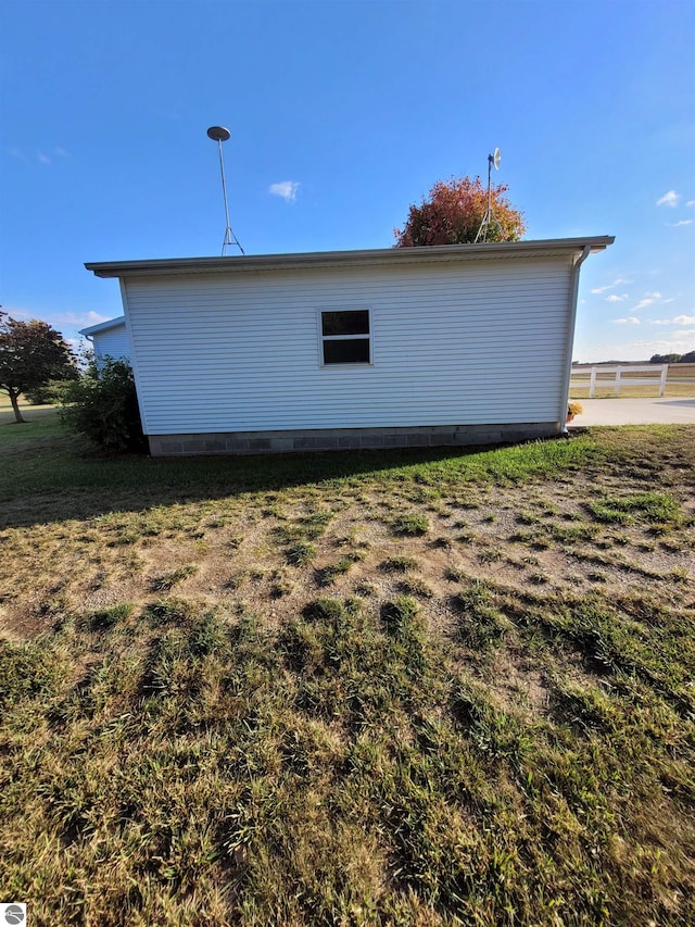 view of side of home featuring a lawn