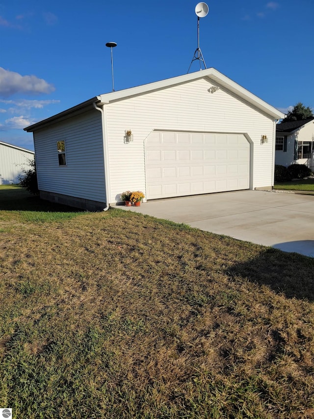 view of property exterior with a lawn and a garage