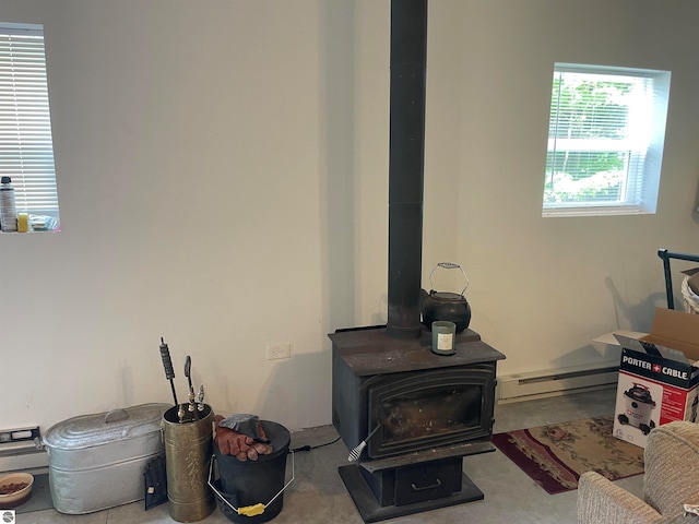 interior details with baseboard heating and a wood stove