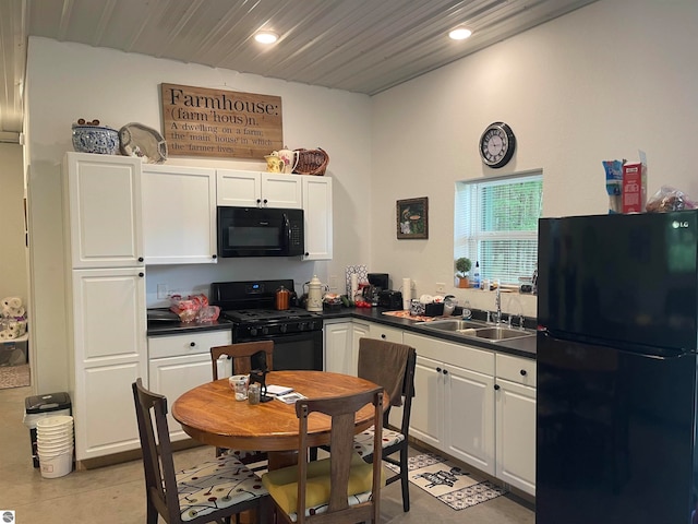 kitchen with white cabinets, black appliances, and sink