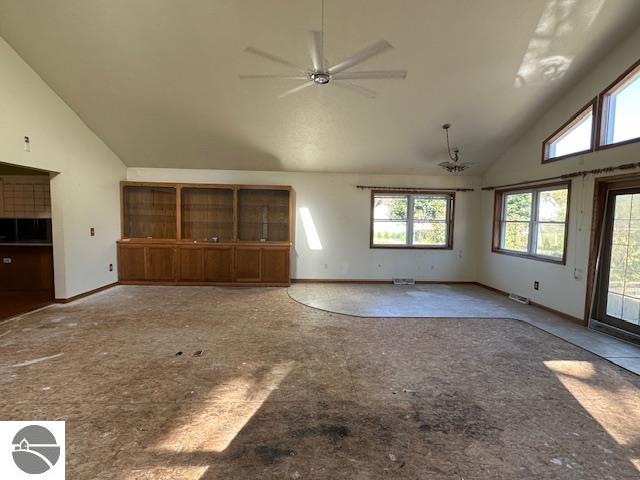 unfurnished living room featuring high vaulted ceiling and ceiling fan