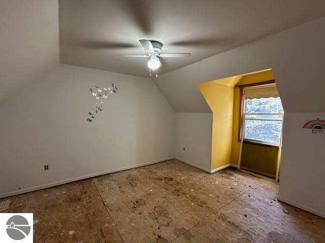 additional living space with ceiling fan and lofted ceiling