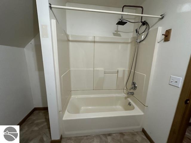 bathroom with bathing tub / shower combination