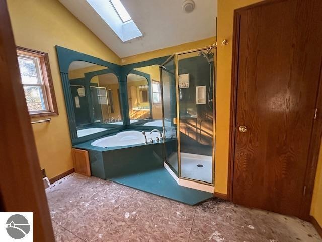 bathroom with shower with separate bathtub, vaulted ceiling, and tile patterned floors