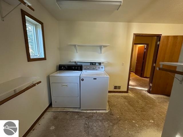 washroom with a barn door and washer and dryer