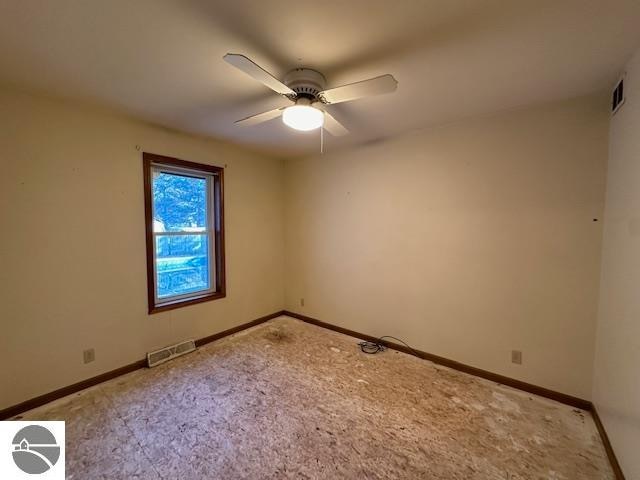 empty room featuring carpet flooring and ceiling fan