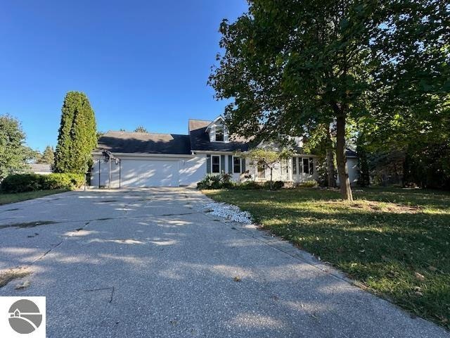 view of front of property featuring a garage and a front lawn