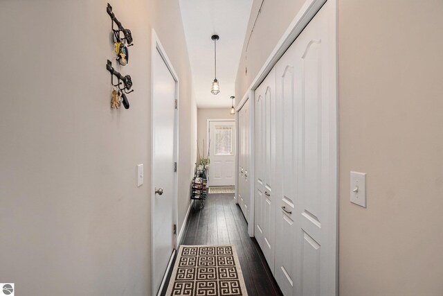 corridor with dark hardwood / wood-style flooring