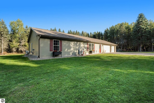 single story home featuring a garage and a front lawn