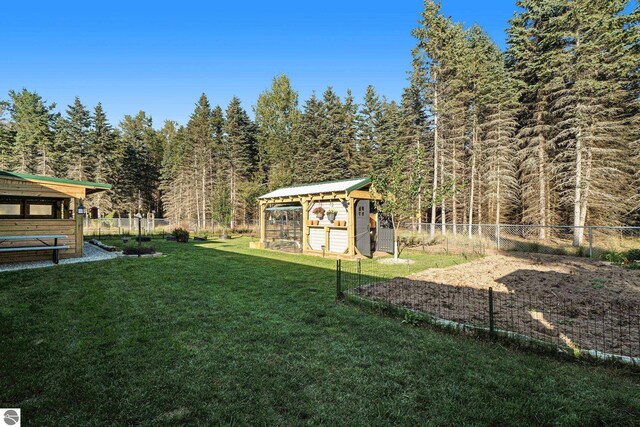 view of yard featuring a gazebo and an outbuilding