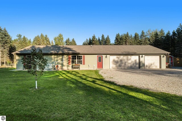 single story home featuring a garage and a front yard