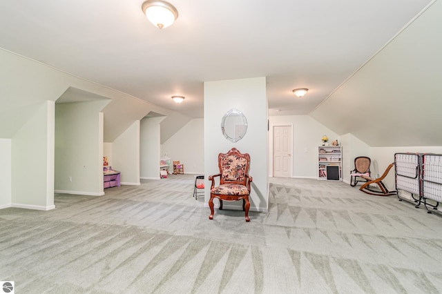 living area with lofted ceiling and light carpet