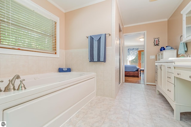 bathroom featuring tile patterned flooring, crown molding, vanity, and a bathing tub