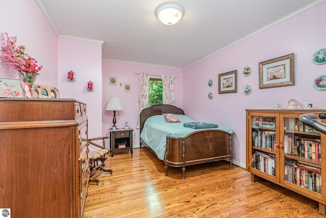 bedroom featuring crown molding and light hardwood / wood-style floors