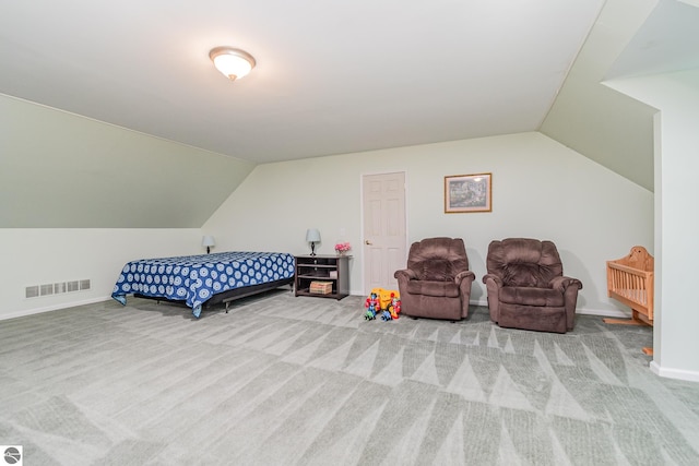 carpeted bedroom with lofted ceiling