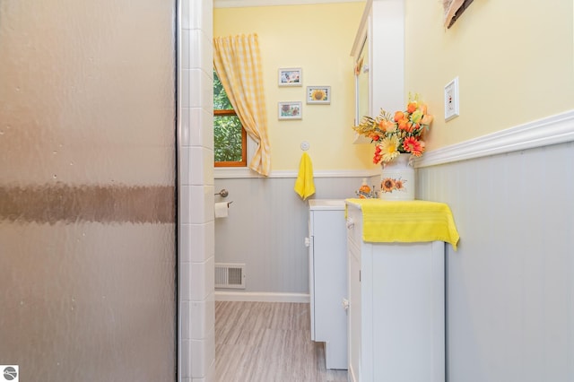 clothes washing area with light wood-type flooring