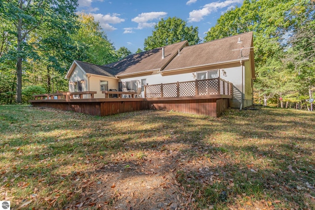 rear view of property with a lawn and a wooden deck