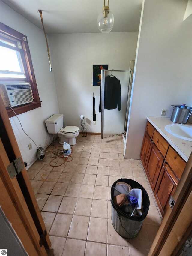 bathroom featuring tile patterned flooring, cooling unit, a shower with shower door, vanity, and toilet