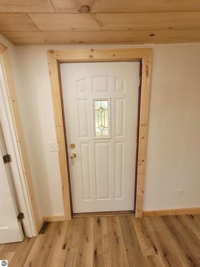 doorway to outside featuring wood ceiling and light hardwood / wood-style floors