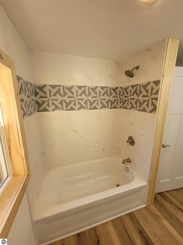 bathroom featuring tiled shower / bath and hardwood / wood-style flooring