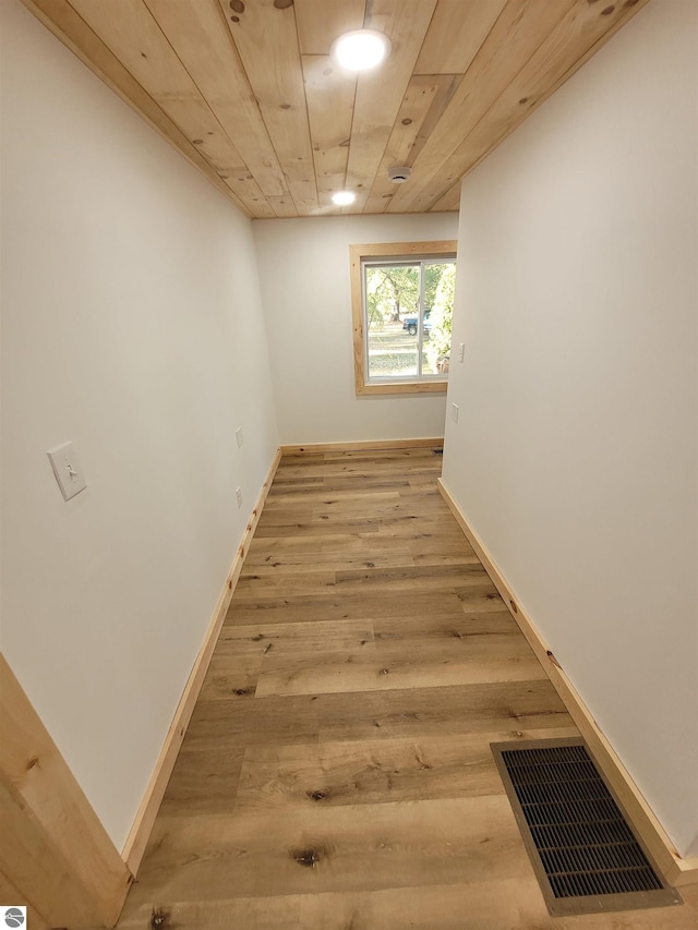 corridor featuring wooden ceiling and light hardwood / wood-style flooring