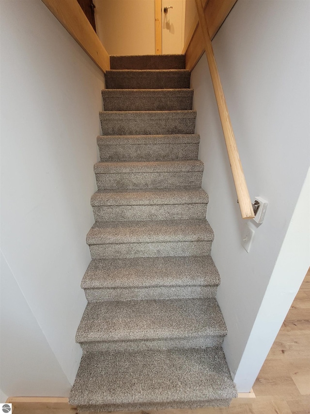 stairway featuring hardwood / wood-style floors