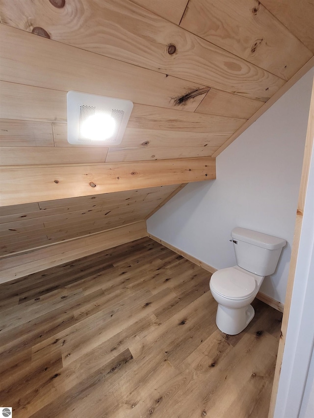 bathroom with wooden ceiling, vaulted ceiling, toilet, and hardwood / wood-style flooring