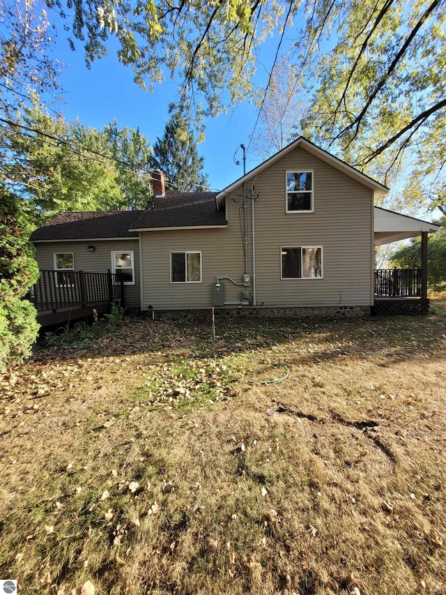 back of property with a wooden deck