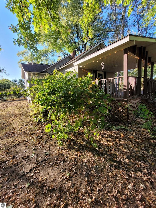 view of side of property with a wooden deck