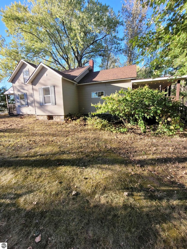 view of property exterior with a yard