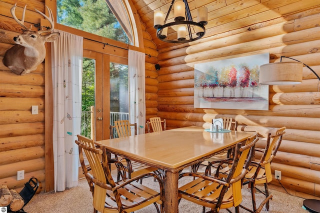 dining room with french doors, a notable chandelier, and log walls