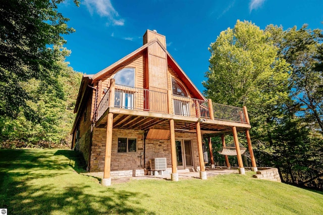 rear view of house with a patio, a yard, a deck, and central AC unit